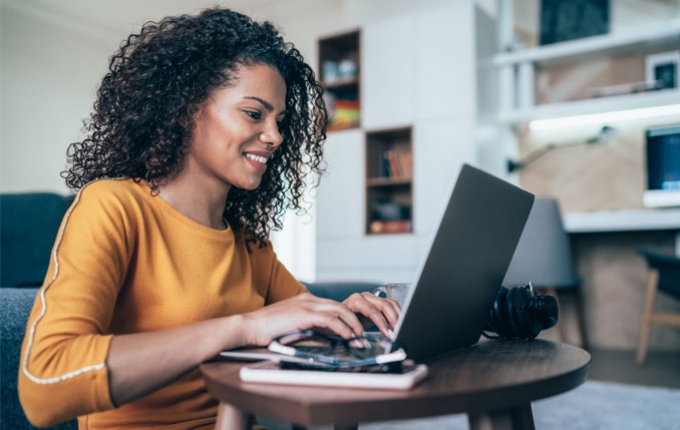 A woman works on her laptop. 